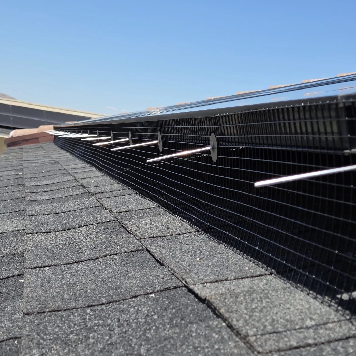 Close-up of galvanized mesh installed around solar panels